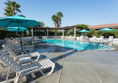 Villa Del Rio Pool with Lounge Chairs and Umbrellas - image